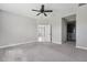 Large primary bedroom featuring soft carpeting, neutral paint, and an ensuite bathroom at 13524 Circa Crossing Dr, Lithia, FL 33547