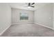 Bedroom features neutral walls, gray carpet, a ceiling fan and one window at 13524 Circa Crossing Dr, Lithia, FL 33547