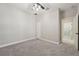 View of the bedroom with neutral walls, gray carpet, ceiling fan and doorway leading to bathroom at 13524 Circa Crossing Dr, Lithia, FL 33547