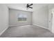 A bright and airy bedroom with a ceiling fan and a large window at 13524 Circa Crossing Dr, Lithia, FL 33547
