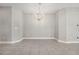 Bright dining room features tile flooring, modern chandelier lighting, and a neutral palette at 13524 Circa Crossing Dr, Lithia, FL 33547