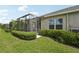 Manicured backyard featuring a screened lanai with well maintained landscaping at 13524 Circa Crossing Dr, Lithia, FL 33547