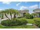 Inviting home exterior featuring a well-manicured lawn and lush tropical landscaping at 13524 Circa Crossing Dr, Lithia, FL 33547