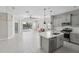 Open concept floor plan with kitchen island and stainless steel appliances at 13524 Circa Crossing Dr, Lithia, FL 33547