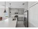 Well-equipped kitchen featuring stainless steel appliances and an island with a quartz countertop at 13524 Circa Crossing Dr, Lithia, FL 33547