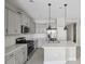 Bright kitchen featuring stainless steel appliances, gray cabinets, and quartz countertops at 13524 Circa Crossing Dr, Lithia, FL 33547