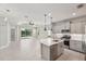 Open kitchen and living area with sliding glass doors to the patio at 13524 Circa Crossing Dr, Lithia, FL 33547