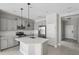 Modern kitchen boasts gray cabinets, stainless steel appliances, a center island, and subway tile backsplash at 13524 Circa Crossing Dr, Lithia, FL 33547