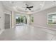 Spacious living room with tile flooring, ceiling fan, recessed lighting, and sliding glass doors to the backyard at 13524 Circa Crossing Dr, Lithia, FL 33547