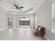Bright living room with tile flooring, tray ceilings, neutral finishes and sliding glass doors to the outdoors at 13524 Circa Crossing Dr, Lithia, FL 33547