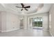 Living room boasts an open layout, tile floors, fan, recessed lighting, and access to the screened-in patio at 13524 Circa Crossing Dr, Lithia, FL 33547