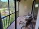 Balcony with tiled floor, two chairs, and a scenic view of the pond and surrounding greenery at 140 Nina Way, Oldsmar, FL 34677