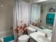 Bathroom showcasing seashell-themed shower curtain and accessories at 140 Nina Way, Oldsmar, FL 34677