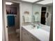 Bathroom with white cabinets and large vanity with stylish fixtures at 140 Nina Way, Oldsmar, FL 34677