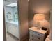 Bathroom next to bedside table with lamp and white drawers at 140 Nina Way, Oldsmar, FL 34677