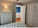 Primary bedroom featuring dresser, large closet, and ensuite bathroom at 140 Nina Way, Oldsmar, FL 34677