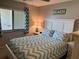 Bright bedroom with a large window and a comfortable bed with beach-themed decor at 140 Nina Way, Oldsmar, FL 34677
