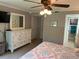 Bedroom with dresser, ceiling fan, and access to bathroom at 140 Nina Way, Oldsmar, FL 34677
