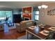 Cozy dining area with dark wood table and chairs adjacent to the living room with natural light at 140 Nina Way, Oldsmar, FL 34677