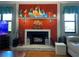 Close-up of an orange fireplace with nautical decor and accent lighting at 140 Nina Way, Oldsmar, FL 34677