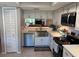 Bright kitchen with stainless steel appliances, a farmhouse sink, and ample counter space at 140 Nina Way, Oldsmar, FL 34677
