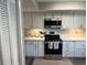 Modern kitchen featuring stainless steel appliances, white cabinets, and sleek countertops, offering a functional and stylish space at 140 Nina Way, Oldsmar, FL 34677