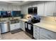 Modern kitchen features stainless steel appliances and bright white cabinetry at 140 Nina Way, Oldsmar, FL 34677