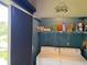 Laundry closet features washer and dryer with storage shelf and sliding door at 140 Nina Way, Oldsmar, FL 34677