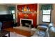 Warm and inviting living room with a decorative fireplace and comfortable seating, perfect for relaxing or entertaining at 140 Nina Way, Oldsmar, FL 34677