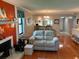 Cozy living room with wood floors, fireplace, and beach-themed decor at 140 Nina Way, Oldsmar, FL 34677
