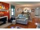 Cozy living room with wood floors, fireplace, and beach-themed decor at 140 Nina Way, Oldsmar, FL 34677