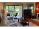 Inviting living room with comfortable seating, a flat-screen TV, and access to an outdoor patio at 140 Nina Way, Oldsmar, FL 34677