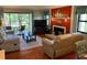Inviting living room featuring a sliding glass door to a balcony and a cozy fireplace at 140 Nina Way, Oldsmar, FL 34677