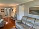 Comfortable living room with hardwood floors, a sofa, and tasteful decor, creating a cozy and inviting space at 140 Nina Way, Oldsmar, FL 34677