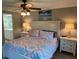 Bedroom features a ceiling fan, two nightstands, and a large bed at 140 Nina Way, Oldsmar, FL 34677