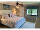 Bedroom featuring a ceiling fan and queen-size bed with decorative pillows and bedspread at 140 Nina Way, Oldsmar, FL 34677