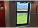 Scenic view from a window overlooking a peaceful lake and lush green surroundings at 140 Nina Way, Oldsmar, FL 34677