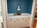 Coastal wet bar features custom cabinets and mini wine storage at 140 Nina Way, Oldsmar, FL 34677
