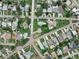 Overhead view displays properties in a verdant neighborhood featuring manicured lawns and tree-lined streets at 1580 Arizona Ave Ne, St Petersburg, FL 33703