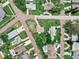 High-angle shot featuring a home on a landscaped lot with mature trees and residential neighborhood at 1580 Arizona Ave Ne, St Petersburg, FL 33703