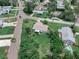 Aerial view of home surrounded by lush, mature trees in a neighborhood with well-maintained lawns and beautiful landscaping at 1580 Arizona Ave Ne, St Petersburg, FL 33703