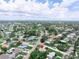 Spacious neighborhood featuring well-maintained homes with mature trees and landscaping under blue skies with fair weather clouds at 1580 Arizona Ave Ne, St Petersburg, FL 33703