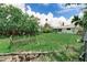 Expansive backyard with mature trees, grassy lawn, and a wooden fence, providing privacy at 1580 Arizona Ave Ne, St Petersburg, FL 33703