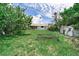 Wide backyard featuring mature trees, a shed, and green grass, offering ample outdoor space at 1580 Arizona Ave Ne, St Petersburg, FL 33703