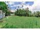 Lush backyard with a shed, mature trees, and a grassy lawn, perfect for outdoor activities at 1580 Arizona Ave Ne, St Petersburg, FL 33703