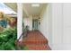 The front porch features brick flooring, white columns, and the front door is light blue at 1580 Arizona Ave Ne, St Petersburg, FL 33703