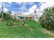 Exterior view showcasing the home's facade amidst lush greenery, creating a natural aesthetic at 1580 Arizona Ave Ne, St Petersburg, FL 33703
