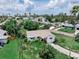 An exterior view shows a quaint home with mature landscaping and a well-maintained lawn in a sunny neighborhood at 1580 Arizona Ave Ne, St Petersburg, FL 33703