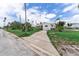 Cute single-story home with a lawn, driveway, and inviting neighborhood street at 1580 Arizona Ave Ne, St Petersburg, FL 33703