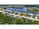 Aerial view of homes along a lake with lush green lawns and mature trees at 1607 New Bedford Dr, Sun City Center, FL 33573